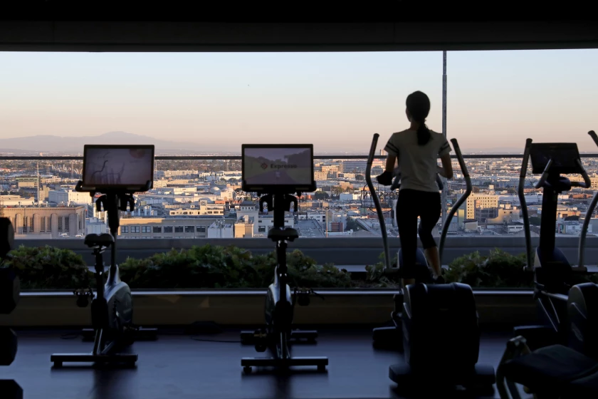 Fitness center with views of downtown at Park Fifth Tower. Amenities that once made apartment buildings stand out are now baseline for high-end complexes. (Gary Coronado / Los Angeles Times)