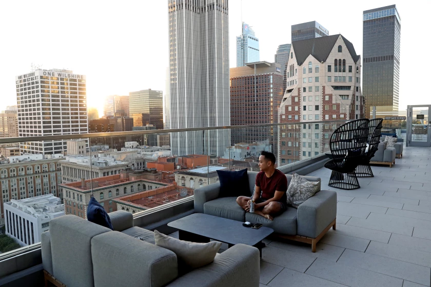 Resident Kevin Aquino relaxes on the rooftop deck at Park Fifth Tower in downtown L.A. (Gary Coronado / Los Angeles Times)